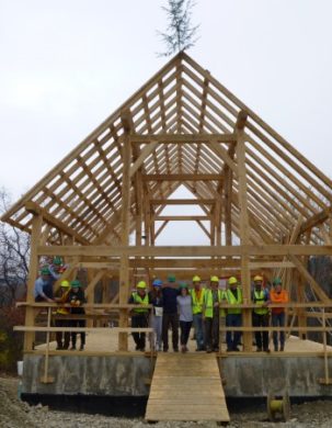 Crew gathers at the end of the timber frame barn raising