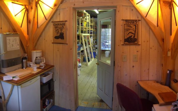 View into timber frame shop through office entryway