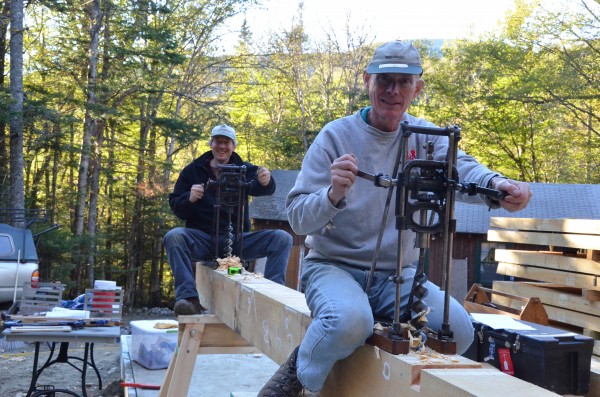 Dartmouth Alumni volunteer and Timberhomes' Josh Jackson make good use of "antique" tools. The timber doesn't stand a chance. 