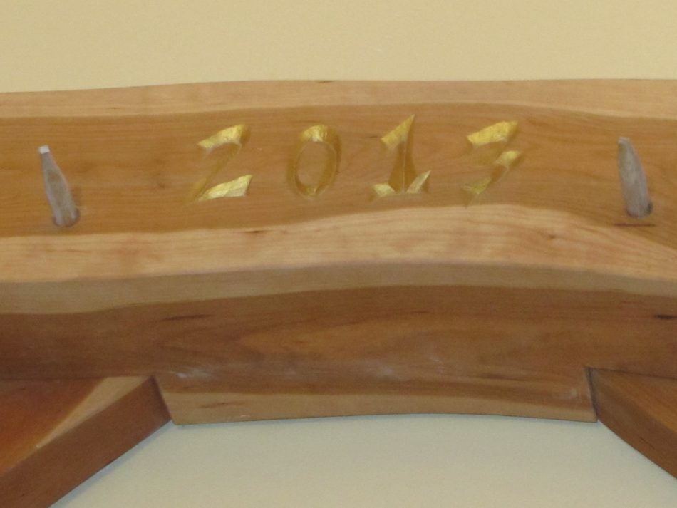 the year 2013 carved into a timber in a timber frame home