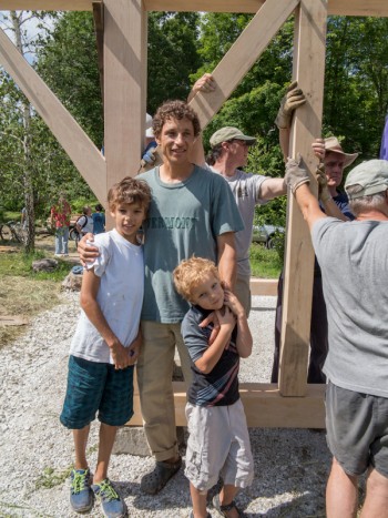 Man and sons who helped raise this timber frame greenhouse