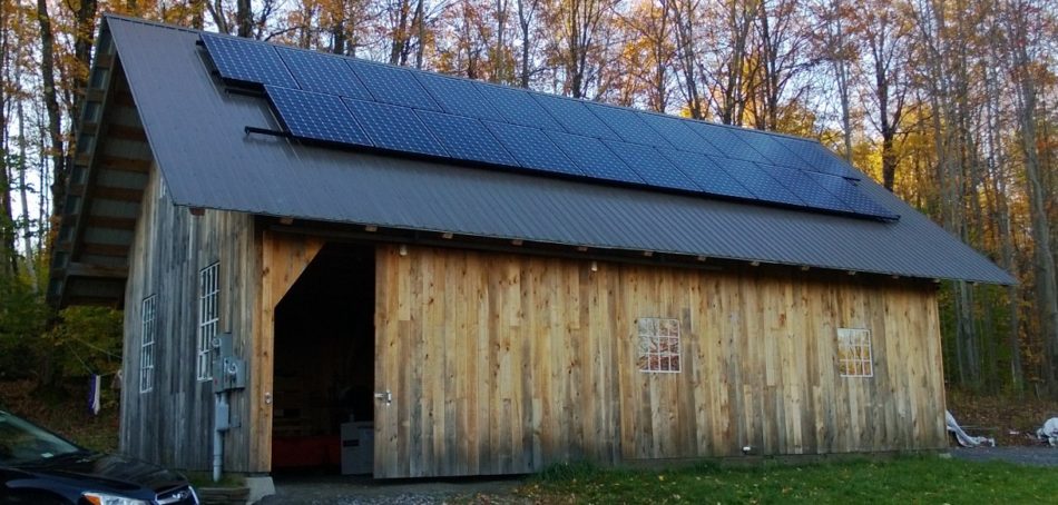 Timber frame barn and boat shed has solar panels mounted to roof