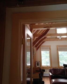 curving cherry braces keep this timber frame addition true