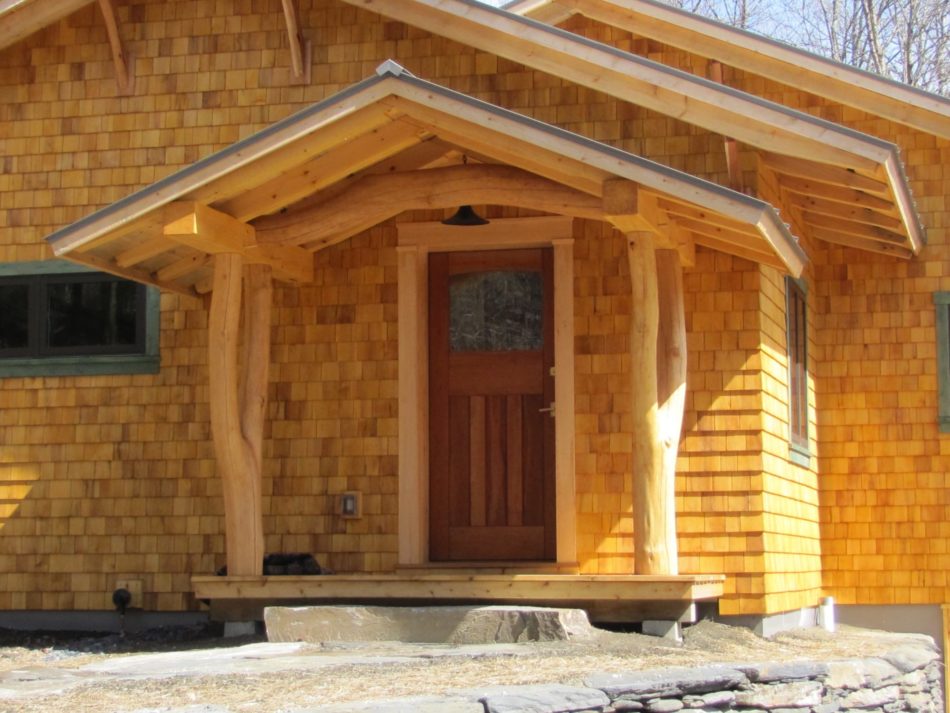 covered entry on cedar shingled home 