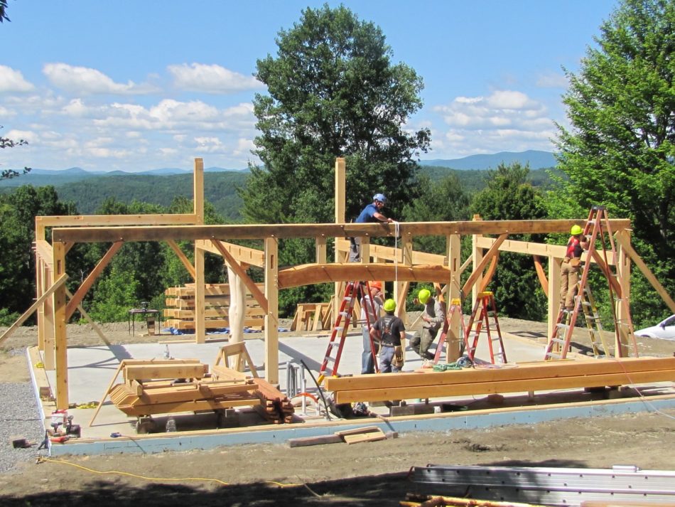 Beautiful day in Vermont timber frame raising curving beam