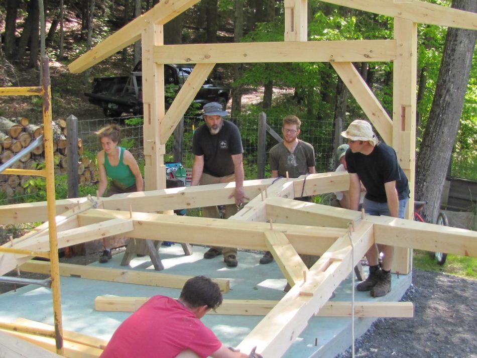 Lifting a crossframe in a timber frame workshop shed