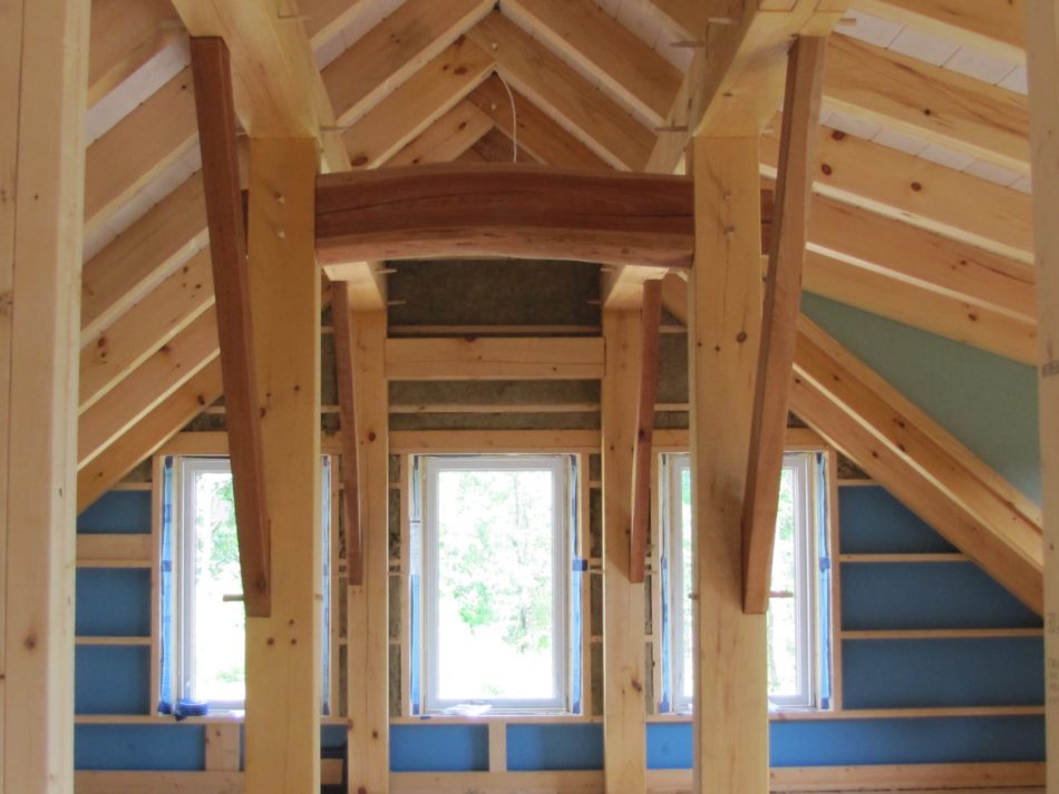 Timber frame corridor with arched beam roxul insulation