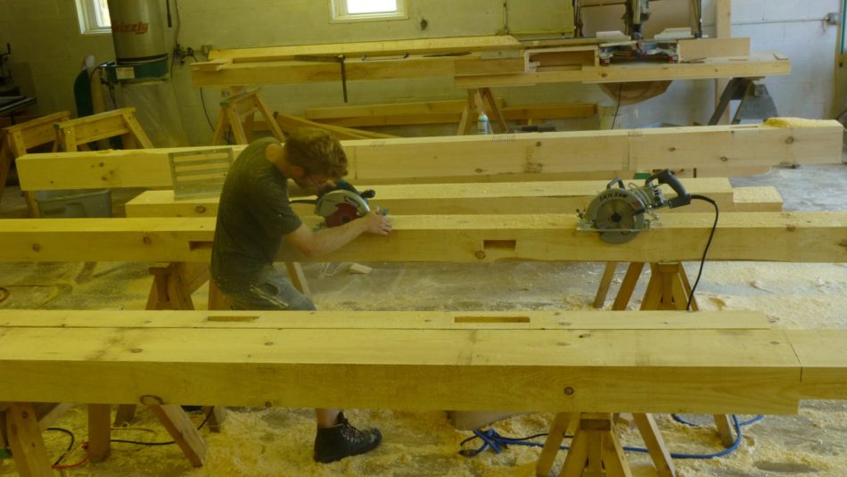 in the shop cutting joints for post and beam outhouse