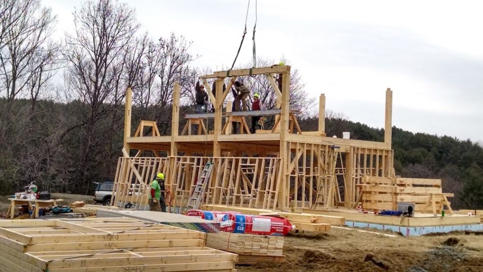 Timber frame raising with stick framed walls