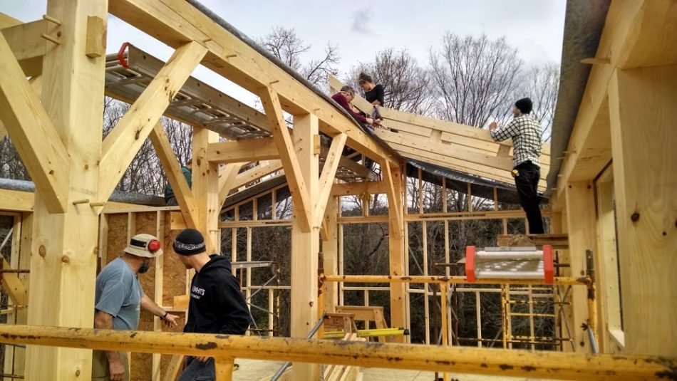 Setting rafter trusses on a timber frame farmhouse