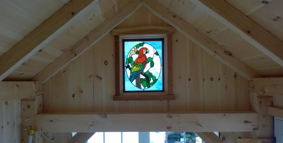 stained glass window in tiny timberframe house.