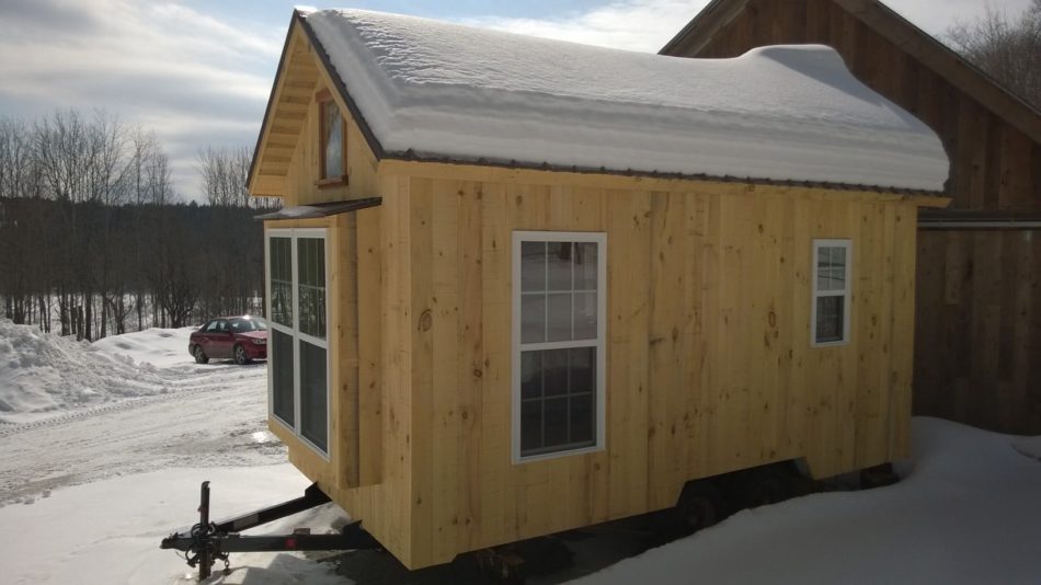 This tiny timber frame is on a trailer, so the owner can tow it wherever they want.