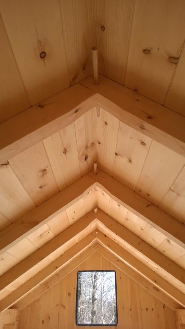 Rafter peaks with mortise and tenon joint in tiny house. View from the loft.