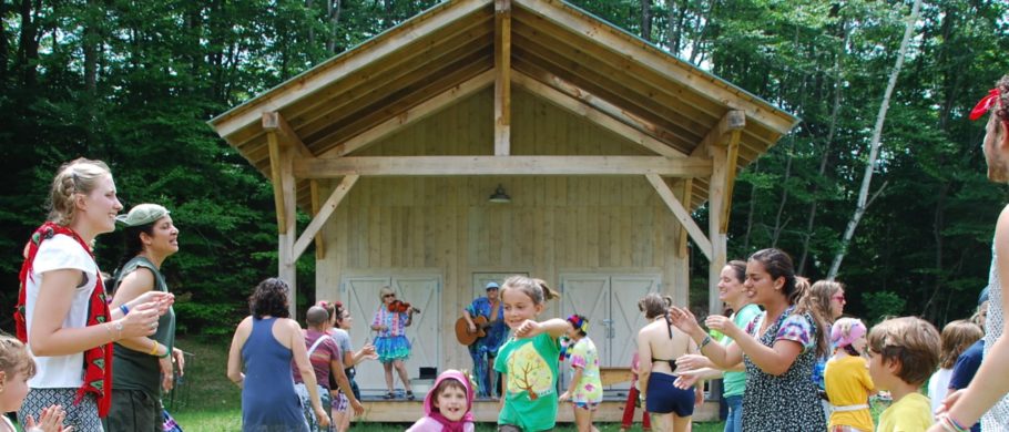 Kids at camp dance in front of a barn