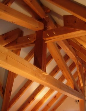King post with a splined joint in the roof of a studio apartment with timber frame rafters