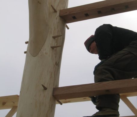 A handrail is installed into the frame of a new post and beam house