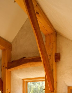 White Pine posts and beams with curving cherry braces against plastered walls