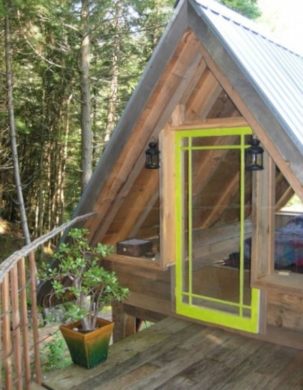 Bright green door to an outdoor sleeping loft