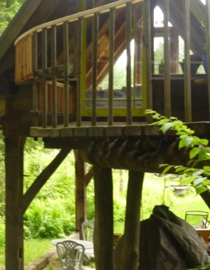 A curving bridge leads to an outdoor sleeping loft