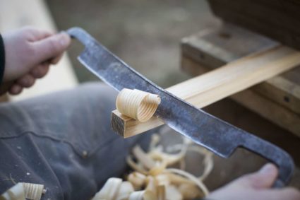 Drawknife shaves away ash curls while making a peg