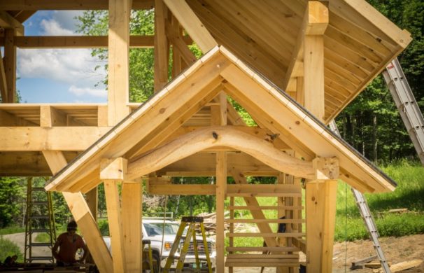 A small gable entry on a timber frame barn with beautiful curving beam
