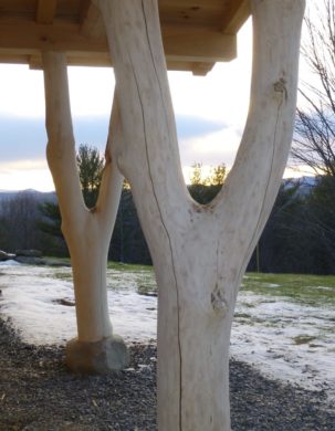 Forked posts carry timber frame entry