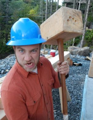 Timber framing workshop participant wielding ridiculously large mallet