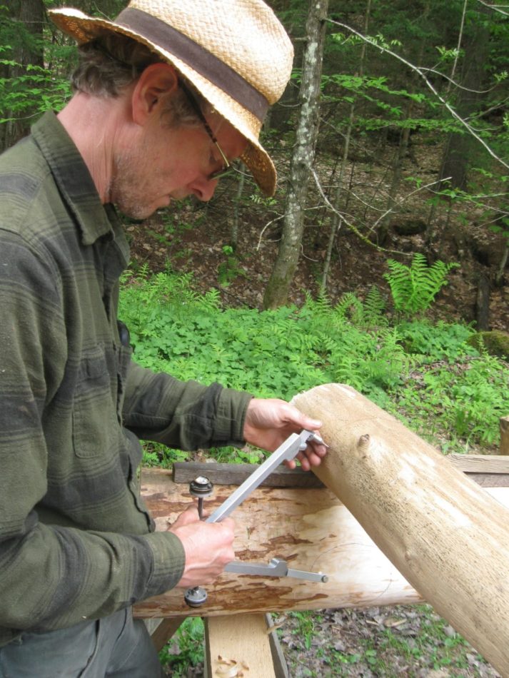 Log scribes are used to layout the joinery on round timbers