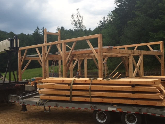 Rafters waiting to be raised onto a timber frame barn