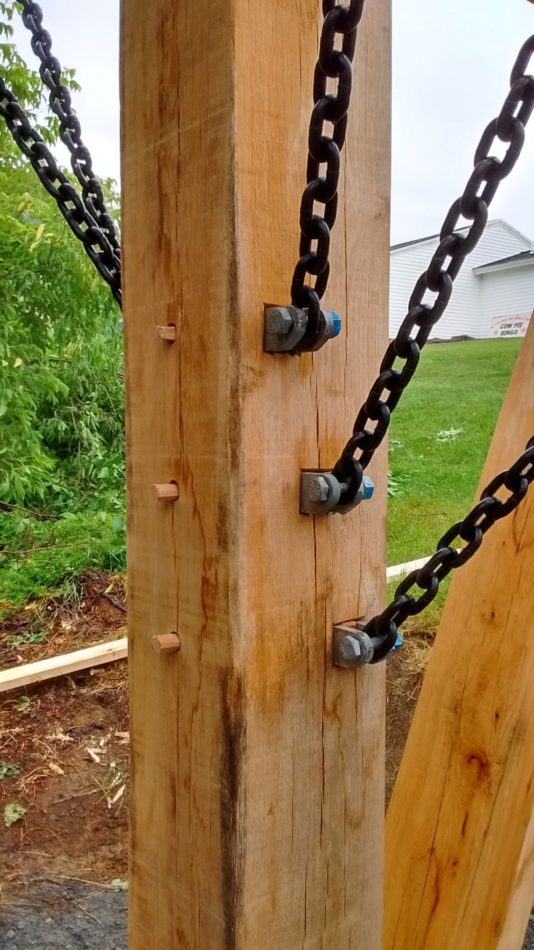 A closeup of the tension brace connection on a timber frame pavilion