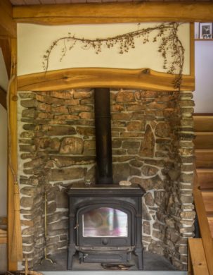 Woodstove and Hearth in straw clay timber frame house
