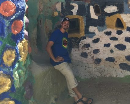 Vermont timber framer Jack Powell in front of a mural