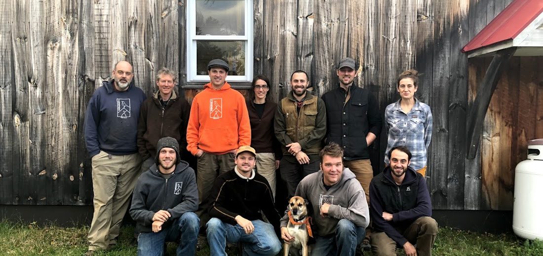 Crew of timber framers in front of their shop