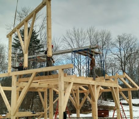 barn ridge and posts being raised by crane