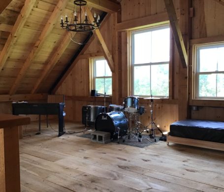 Drum kit set up in a post and beam barn
