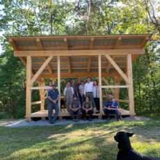 Friends and Family gather under the roof of a new timber frame woodshed raised in New York State