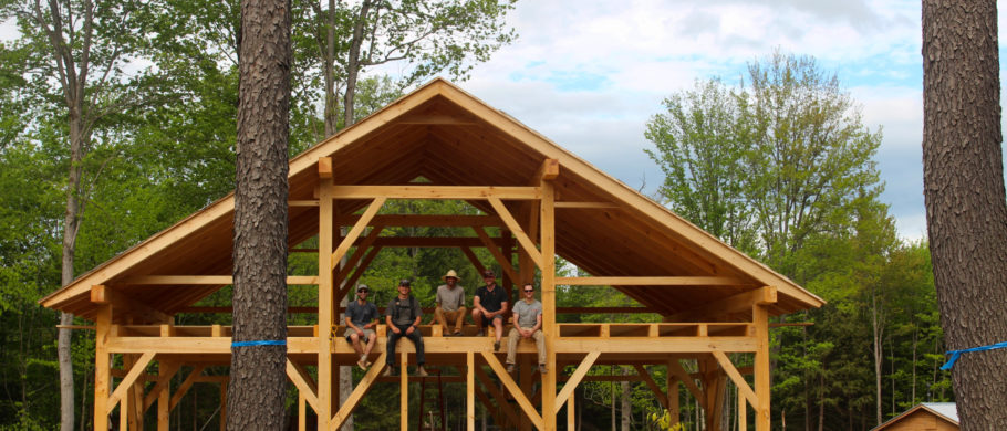 The TimberHomes Vermont raising crew sitting on the second floor of the finished barn
