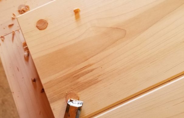 Closeup shot of a woodworker finished joinery in a door.