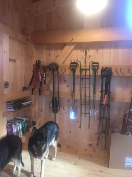 Storage for garden tools inside a timber frame garden shed