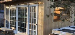 Big sliding doors on the exterior of a timber frame cabin