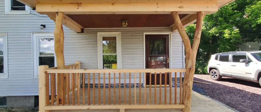 A timber framed porch in Montpelier, VT with forked posts holding up the roof.