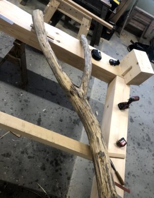 A forked post is set on a timber post and beam, ready to be scribed and fit into a timber frame.