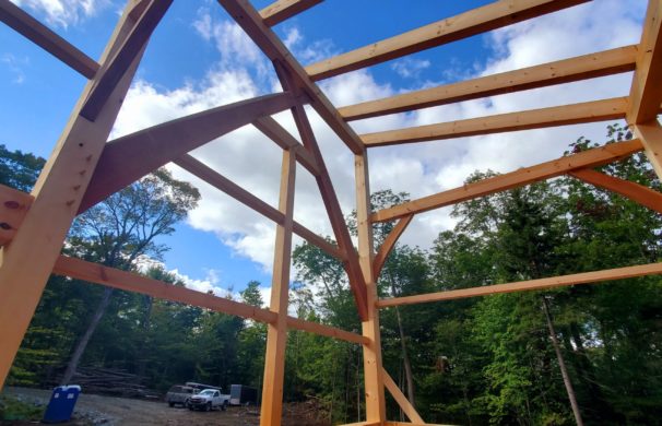 Timber Frame home in Huntington, Vermont with a blue sky background.