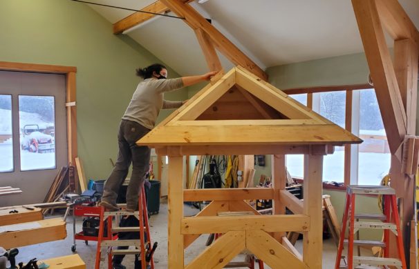 with the cupola timber frame complete, installation of the roof boards begins