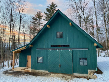 Finished timber frame barn with painted pine siding