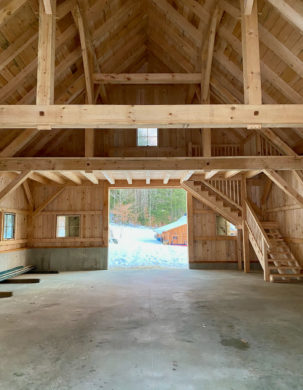 Queen posts in a truss in a timber frame barn