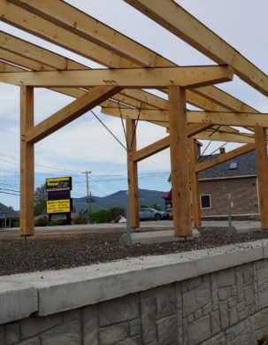 A timber frame in Vermont that will receive solar panels and be used as a carport