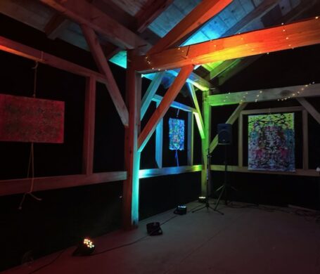 the timber frame is illuminated with lots of colors of light