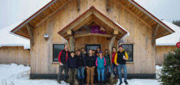 The worker owned cooperative members of TimberHomes Vermont standng in front of their Montpelier wood shop