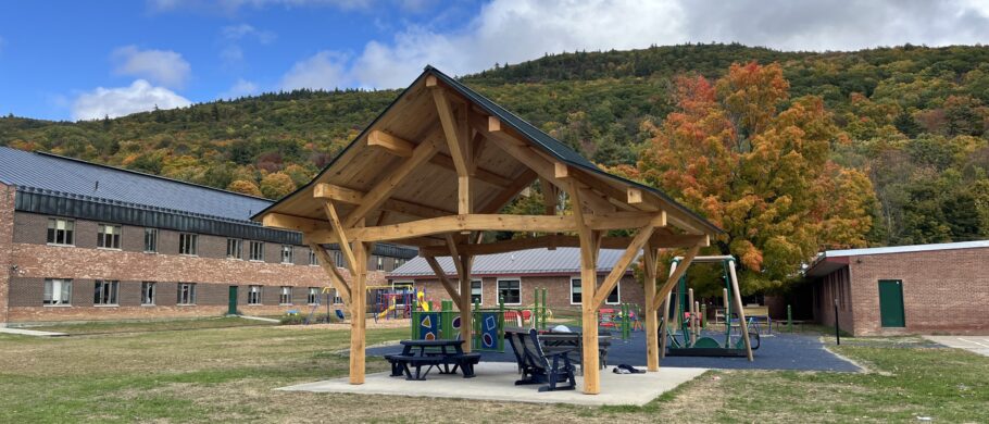 Beautiful timber framed pavilion in Vermont with a blue sky and white clouds